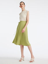 A lady wears a light green skirt.